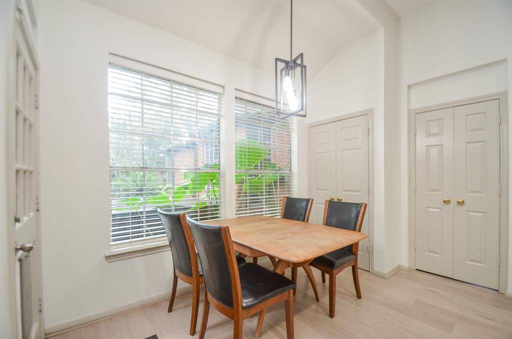 This is a bright, cozy eating area featuring large windows allowing natural light