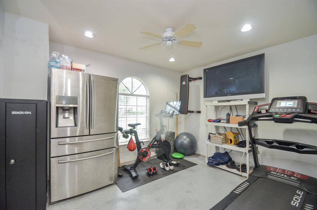 This room is a multi-functional space, currently set up as a home gym. It features good natural light  and is equipped with a ceiling fan and air conditioned..