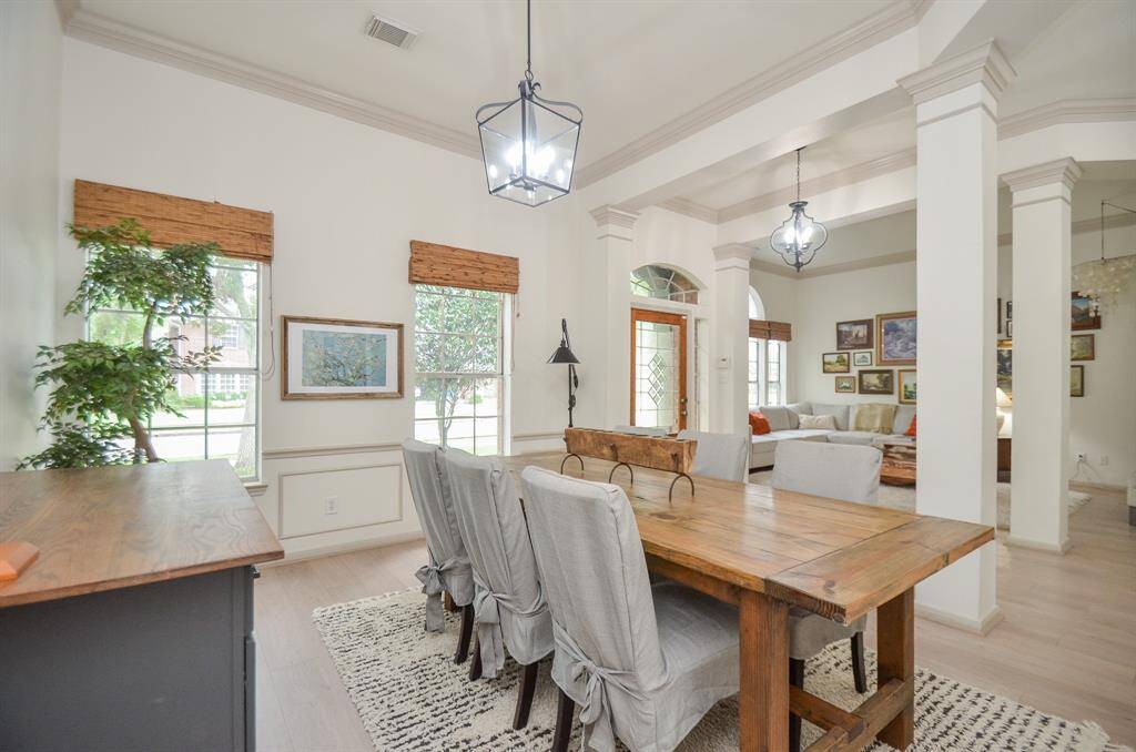 This is a spacious, well-lit dining area featuring high ceilings.