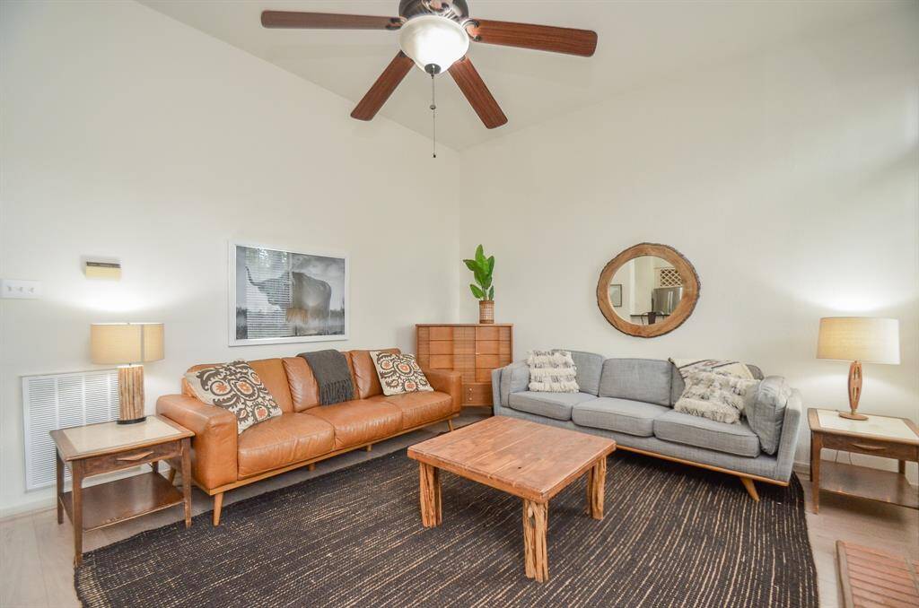 Spacious living room with high ceilings and ample natural light.