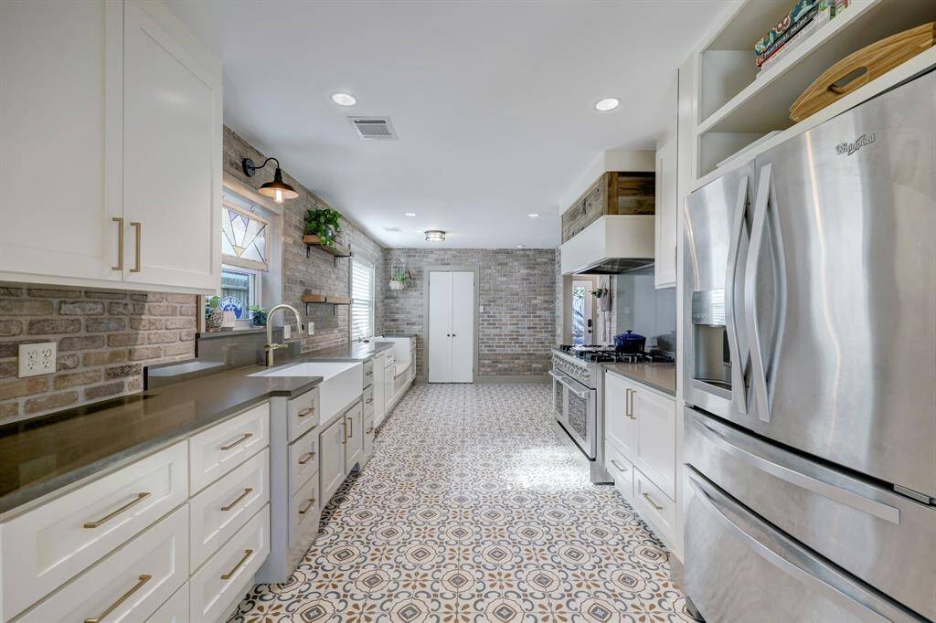 Oversized fridge with double doors, extra slide out tray, water and ice dispenser, pull out freezer.