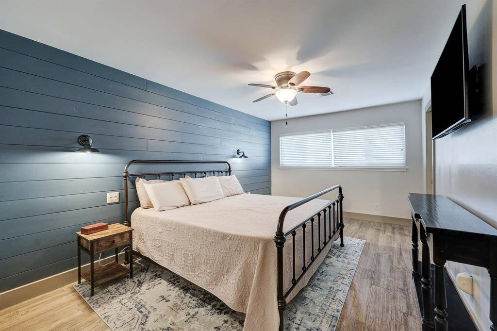 Primary bedroom with a captivating ship lap accent wall