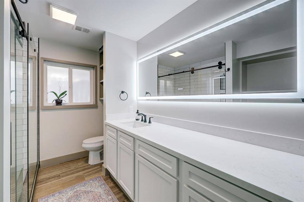 Primary bathroom includes a renovated vanity, plenty of counter space for day to day care, and a touch mirror with great lighting.