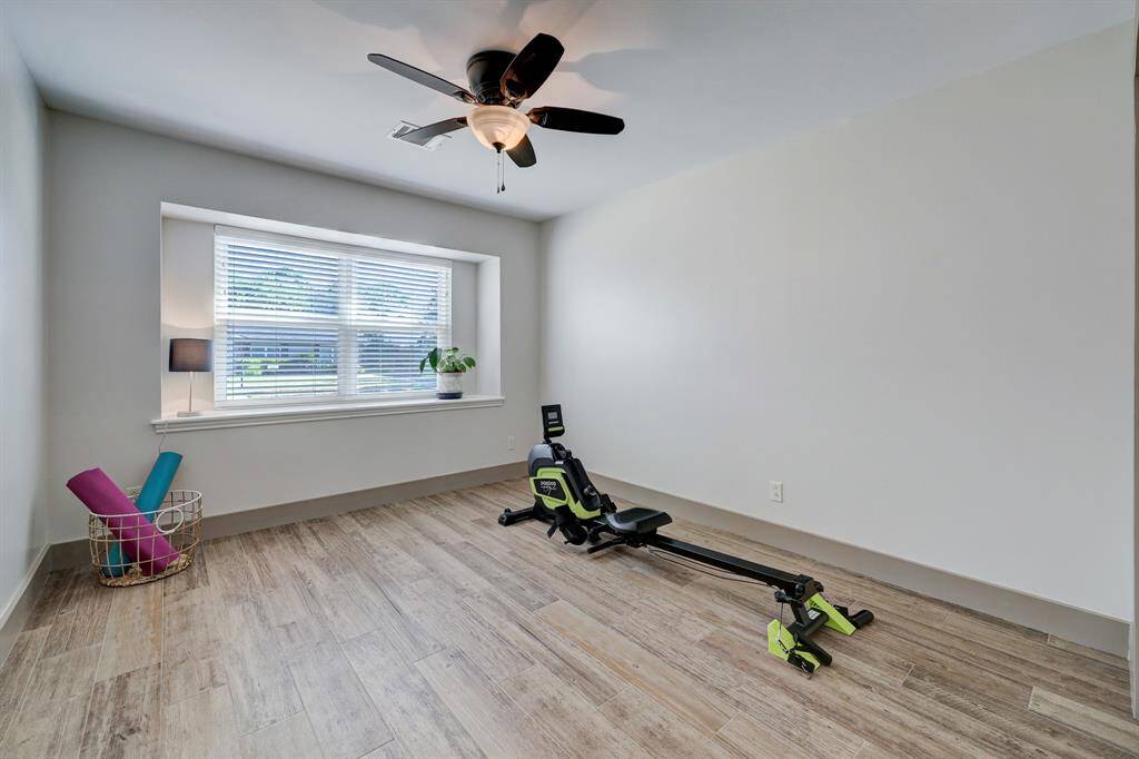 Additional bedroom with large recessed window overlooking front yard.