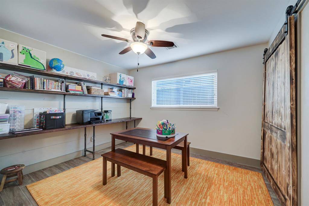 Additional bedroom with sliding closet barndoor, adding style to the room and bringing the house aesthetic together.