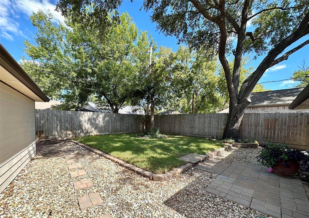 Mature trees offer plenty of shade in the yard for relaxation, play, gardening, or entertaining.