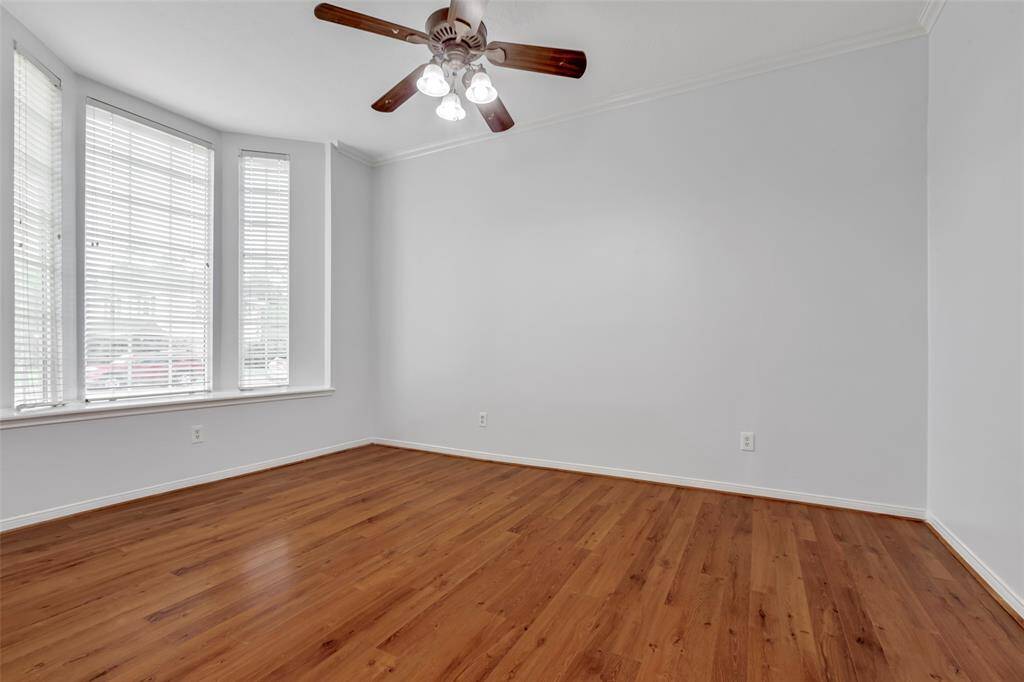 Home office, study or game room with natural lights, ceiling fan and beautiful laminated floors.