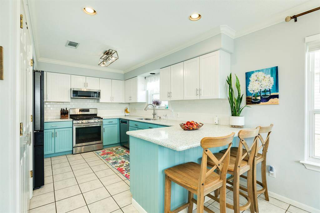 The kitchen is bright & cheery with the choice of colors and materials used.