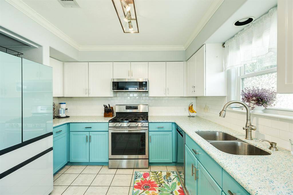 The galley style kitchen is very efficient including plenty of upper and lower cabinets for storage and surrounding countertop space.