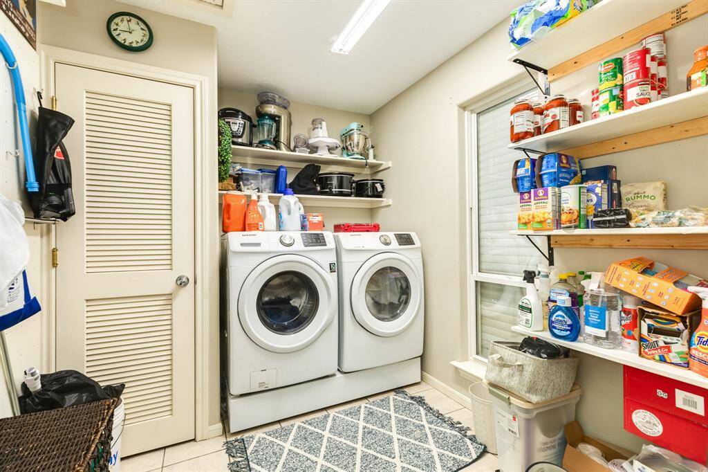 Nice large utility room upstairs with pantry storage.