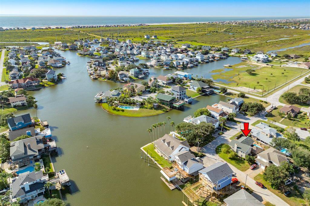 Aerial view of home showing location in the subdivision. It is a short golf cart ride to the beach!