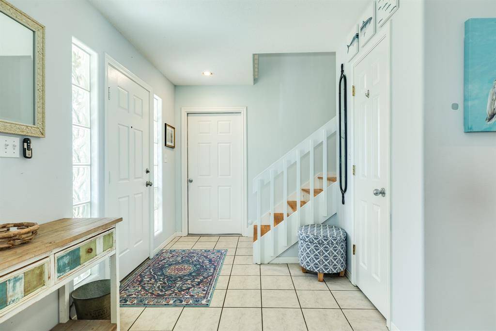 Front entrance into home. Door in view against back wall leads into the garage, and of staircase leads up into 2nd level of home.