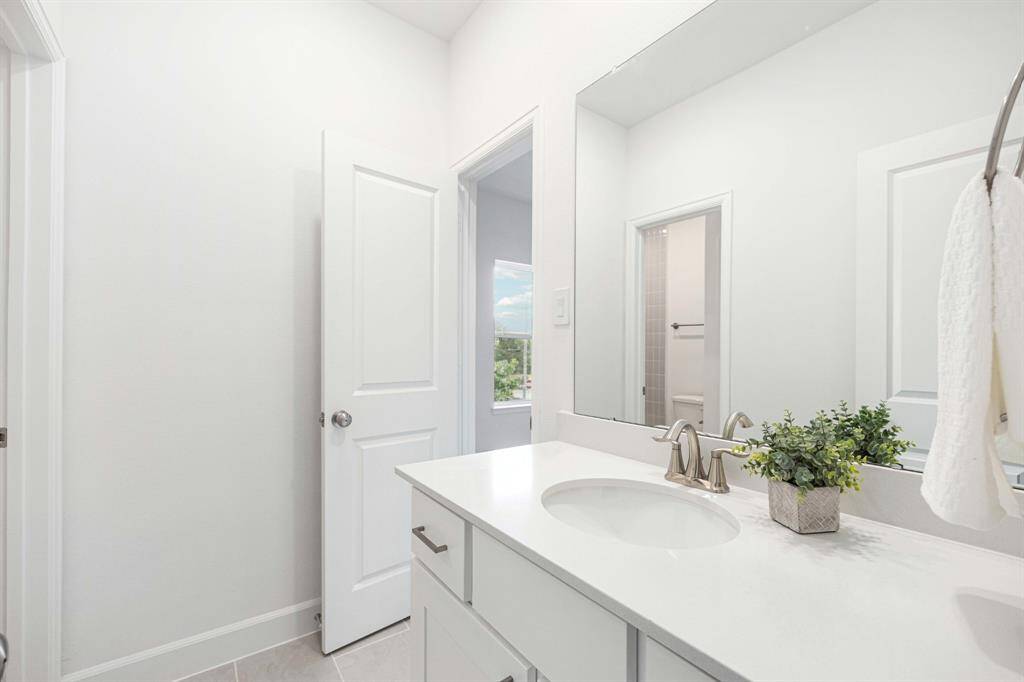 Style meets function in this fresh upstairs bath—with quartz counters, soft-close cabinetry, and fixtures that just feel luxe.