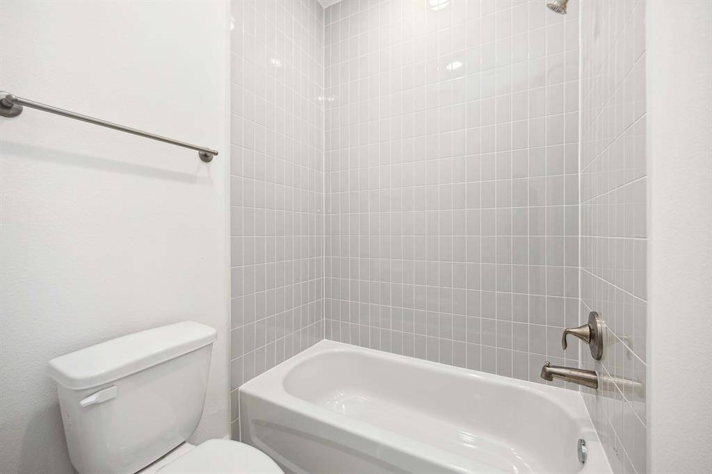 Privacy where it counts, and style that goes all the way up. Full-height tile and thoughtful design make this space a quiet standout.