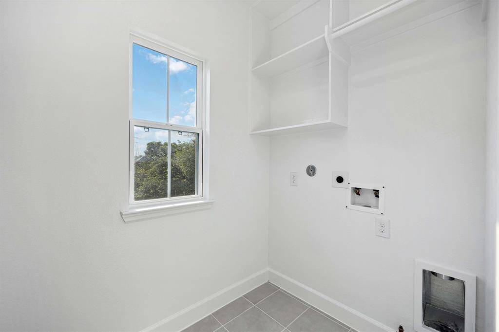 A laundry room you’ll actually want to use. Built-in shelving, hanging space, and even a window to make chores feel just a little lighter.