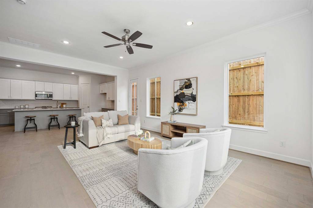Open-concept goals. The transition from living to kitchen is effortless, with warm wood floors and clean lines that make everything feel connected and calm.