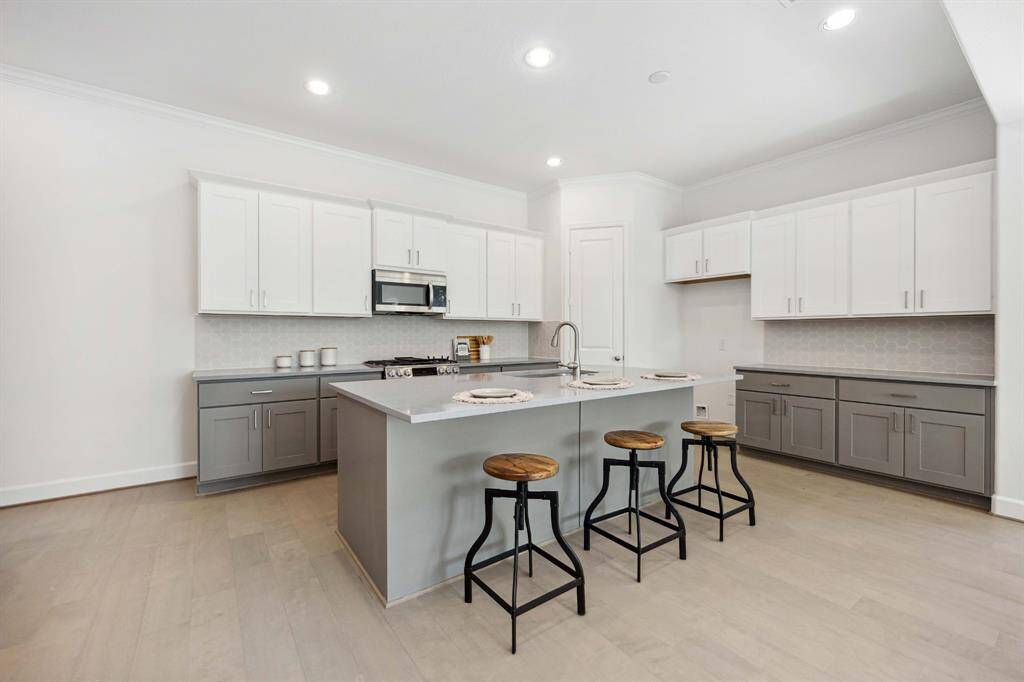 This kitchen checks every box: two-tone Benedettini cabinetry, quartz counters, upgraded pulls, and a big island that’s perfect for everything from pancake breakfasts to wine night.