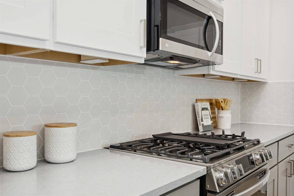 The kind of kitchen details that stop the scroll. Upgraded backsplash, brushed hardware, and custom cabinetry all come together to make this space seriously swoon-worthy.