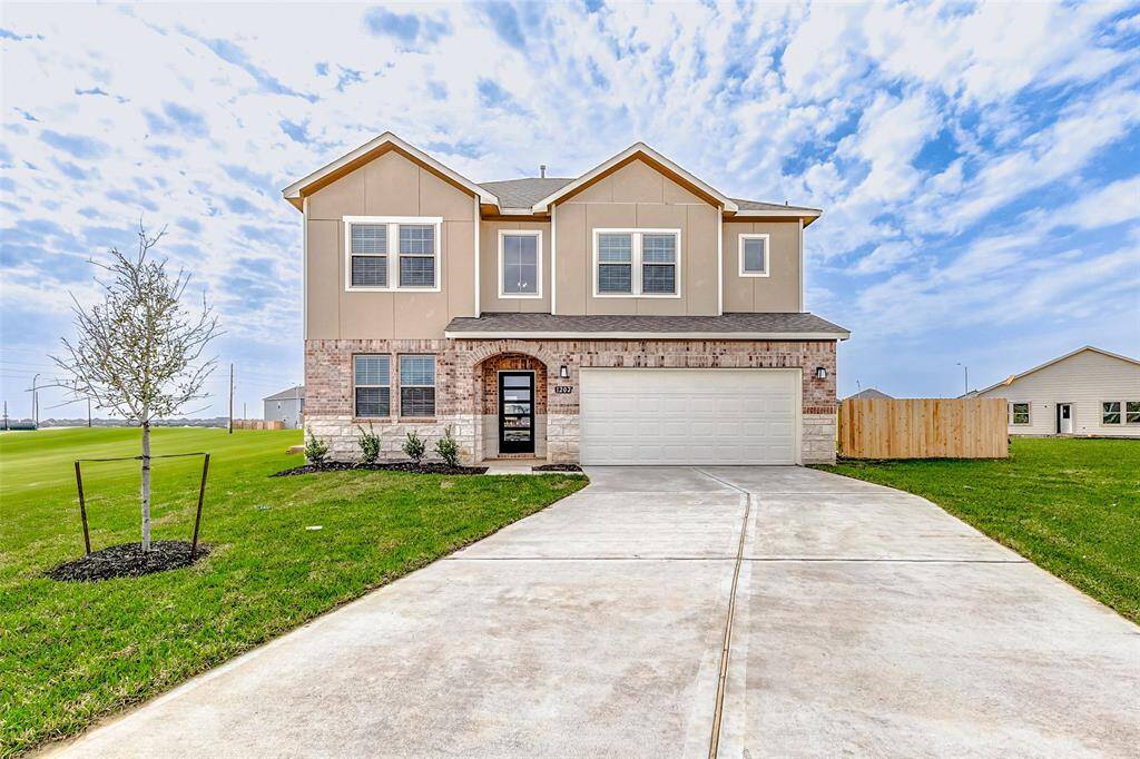 Welcome to this stunning two-story home featuring a charming brick and stone exterior, beautifully manicured landscaping, and a spacious two-car garage. The inviting entryway sets the tone for a warm and welcoming interior. **This is a picture of a Rylan Floor Plan from another Saratoga Homes.**