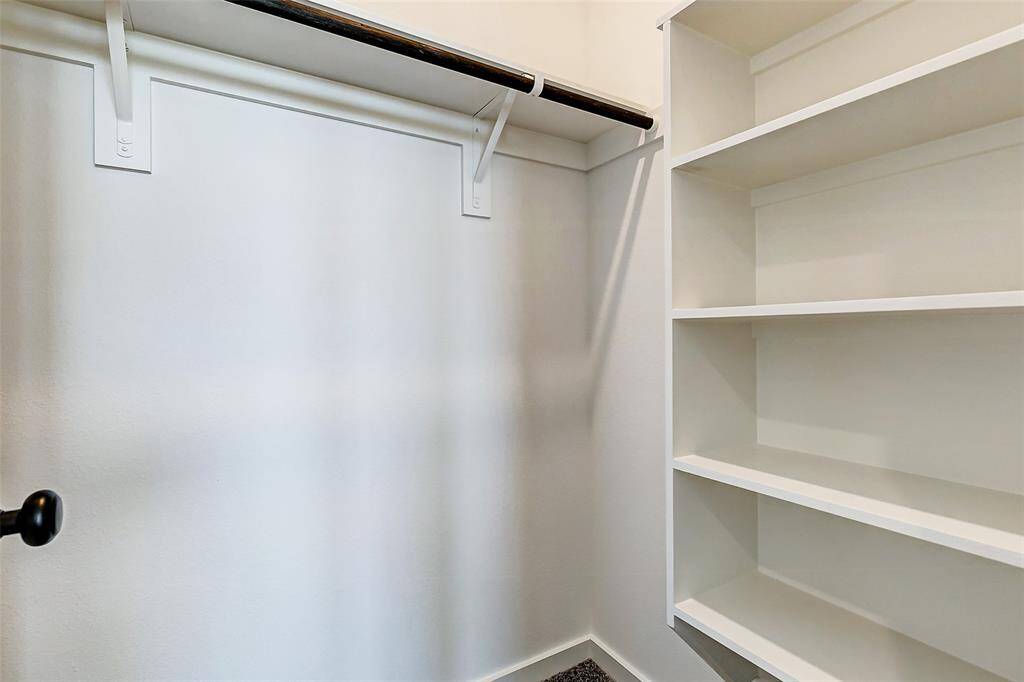Organize with ease in this spacious closet with built-in shelving and ample hanging space—designed for maximum functionality. This is a picture of a Rylan Floor Plan from another Saratoga Homes.