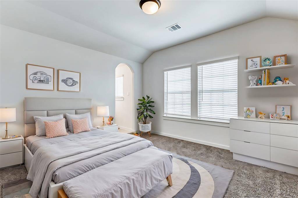 This charming bedroom features architectural details and large windows that bathe the space in natural light. A perfect sanctuary for rest and relaxation. **This is a picture of a Rylan Floor Plan from another Saratoga Homes.**