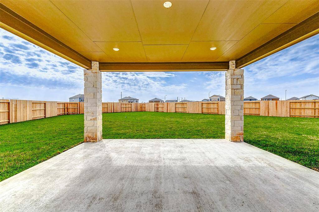 Step onto the covered patio and enjoy the vast backyard with lush green grass and a fully fenced perimeter for privacy. Whether entertaining guests or savoring peaceful mornings, this space is ideal for outdoor living. **This is a picture of a Rylan Floor Plan from another Saratoga Homes.**