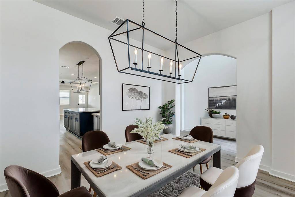 Modern elegance meets functionality! This open-concept layout seamlessly connects the dining area to the kitchen, creating an ideal space for entertaining guests and daily living. **This is a picture of a Rylan Floor Plan from another Saratoga Homes.**
