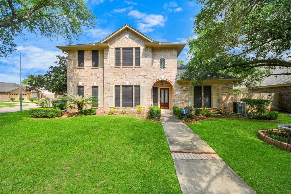 Beautifully crafted two-story brick home with a three-car detached garage, ideally situated on a corner lot in the Pecan Grove community of Richmond, Texas.