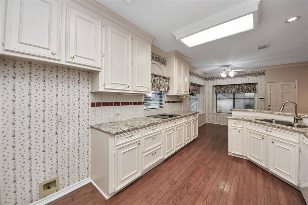 Another view of the kitchen highlights the spacious area designed to accommodate a full-size refrigerator.