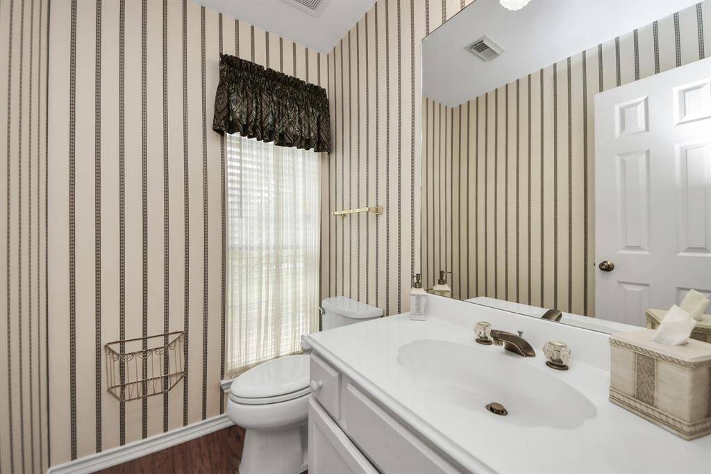 A conveniently located powder bath is perfect for guests, adding comfort and practicality when entertaining.