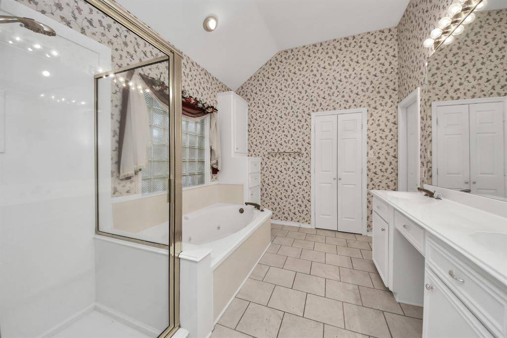 A spacious shower and jetted tub provide relaxing options for those who enjoy either a quick rinse or a leisurely soak.