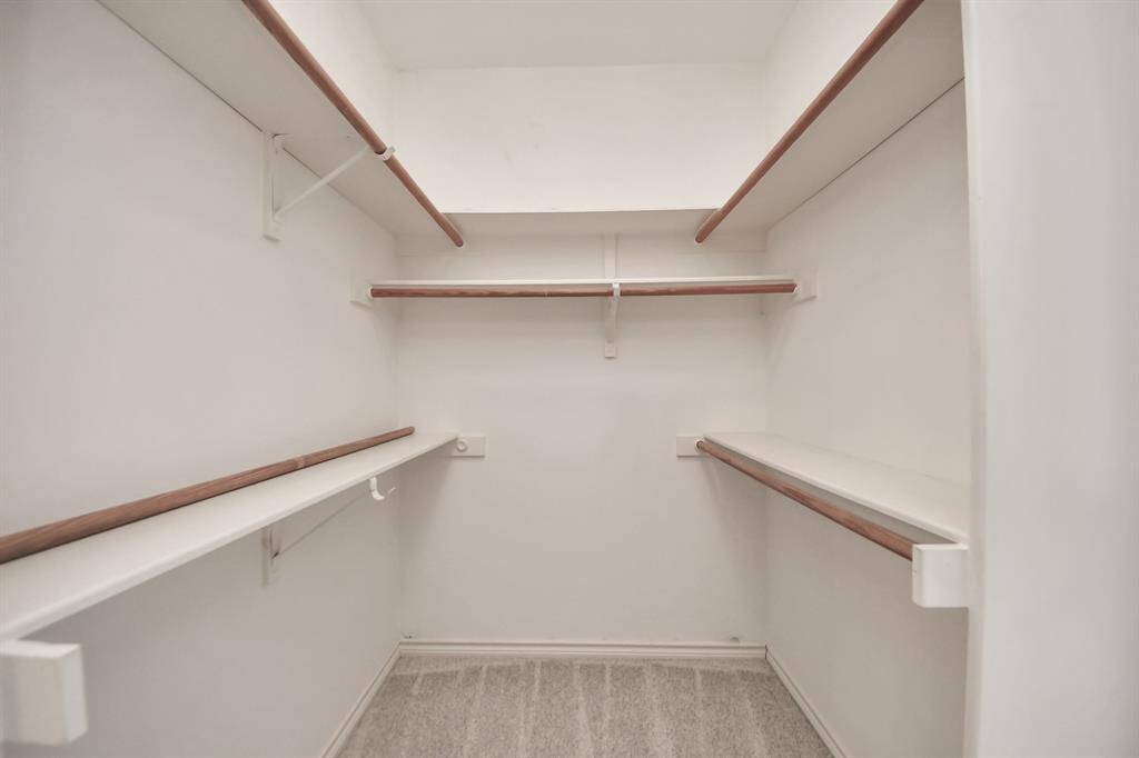 A spacious walk-in closet offers the perfect solution for organized storage of clothing, shoes, and accessories.