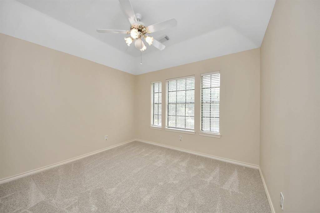 One of three generously sized secondary bedrooms upstairs, offering plenty of space for everyone to have a room to call their own.