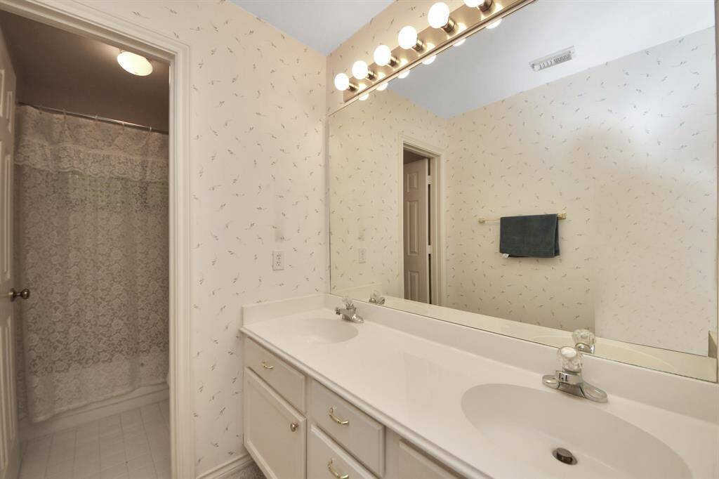 A well-appointed bathroom serves the three secondary bedrooms upstairs, providing convenient access and functionality.