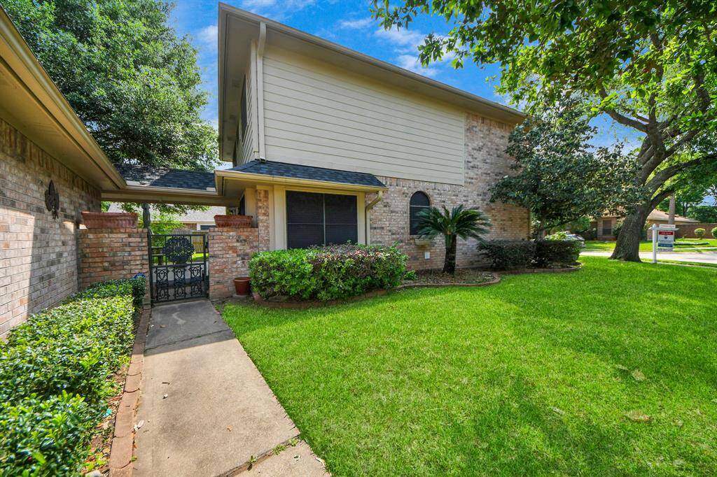 This additional side yard, complete with gate access to a back door and the backyard, offers a nice, open space for easy outdoor access.