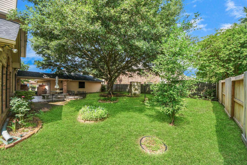 This private backyard has an abundance of space, whether you are relaxing under the shade of a mature tree or envisioning a future swimming pool.