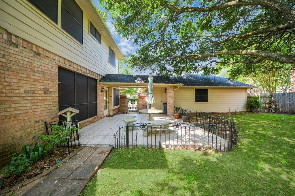 There is plenty of room for kids to play or to create an outdoor kitchen or barbecue pit, making this backyard ideal for both fun and entertaining.