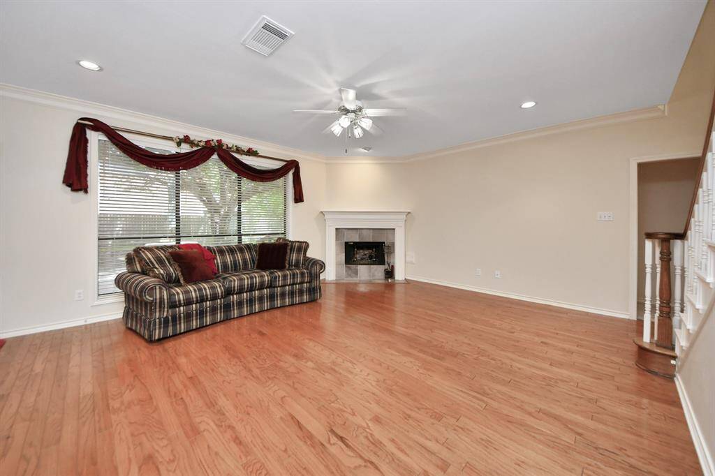 The corner fireplace creates a cozy ambiance perfect for relaxing on chilly evenings. This spacious den allows you to arrange the layout to suit your needs.