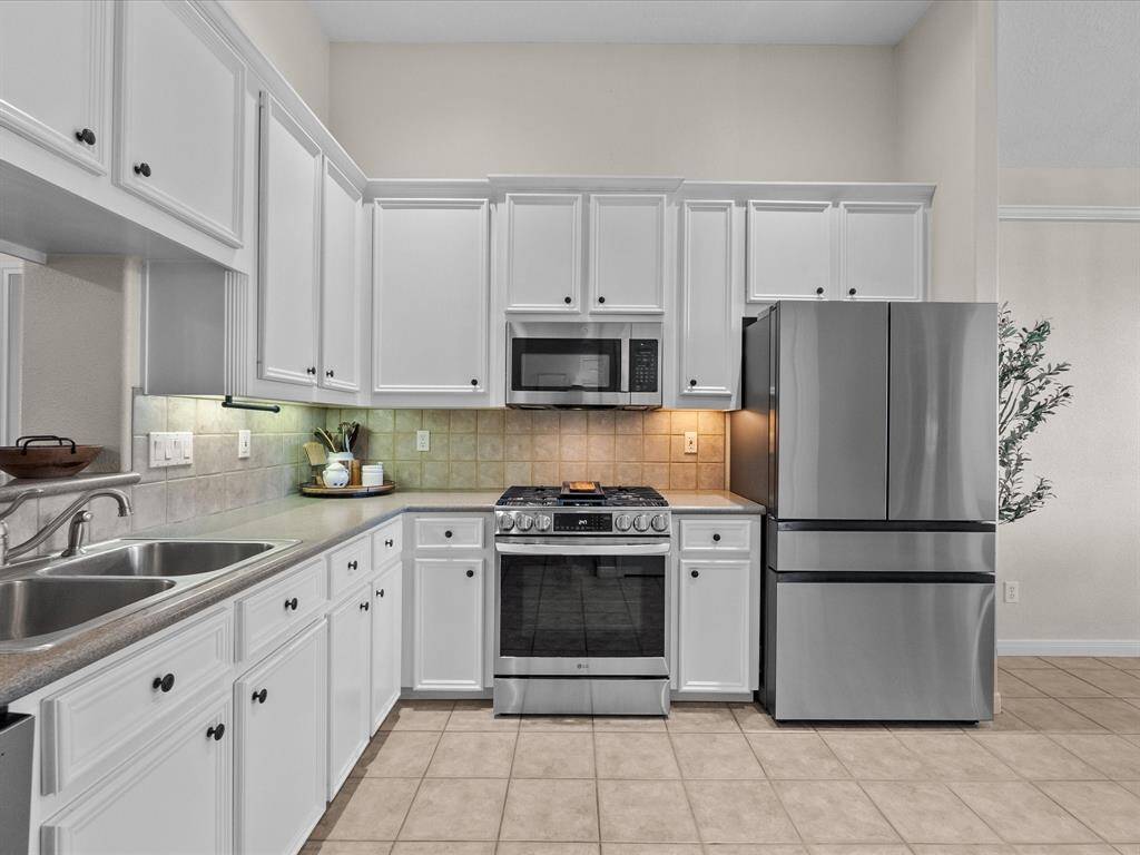 View of the kitchen from the dining area. Doors are to butlers pantry
