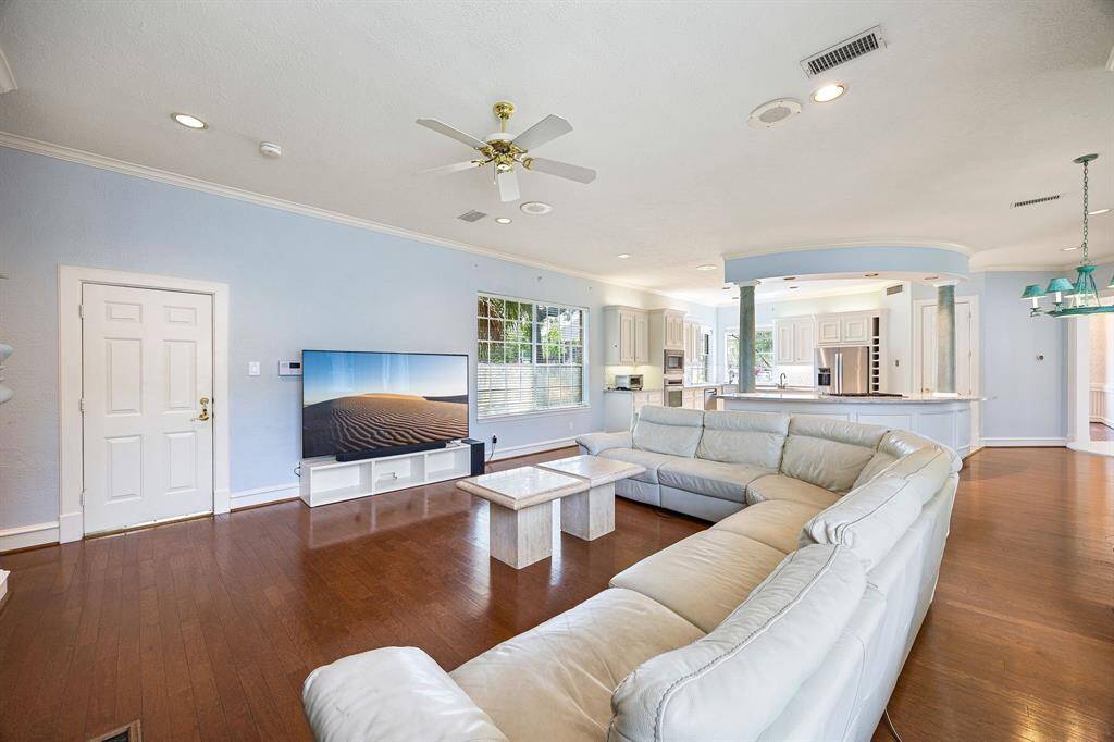 View of family room with access to outdoor pool/spa and one of two staircases to the second level.