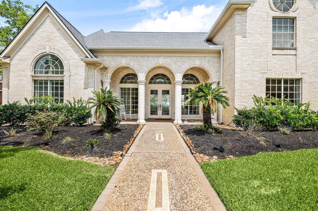 A warm welcome starts here — timeless curb appeal with the space to match with a large covered front porch & a custom-designed front walkway