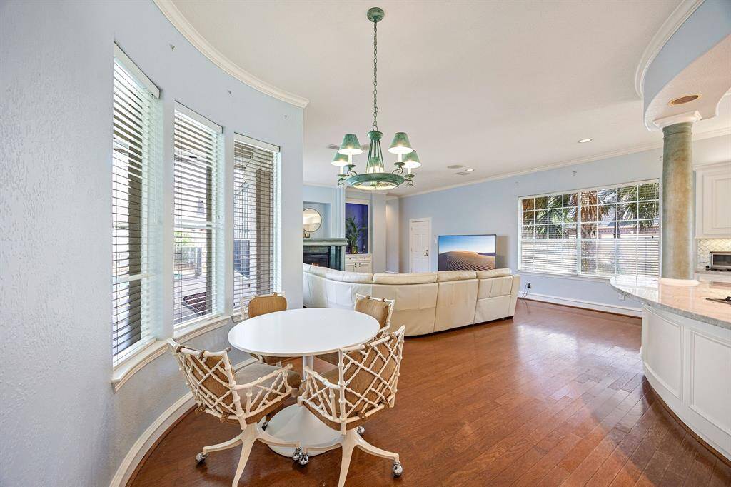 Formal dining room off of kitchen with hardwood flooring and large seating capacity