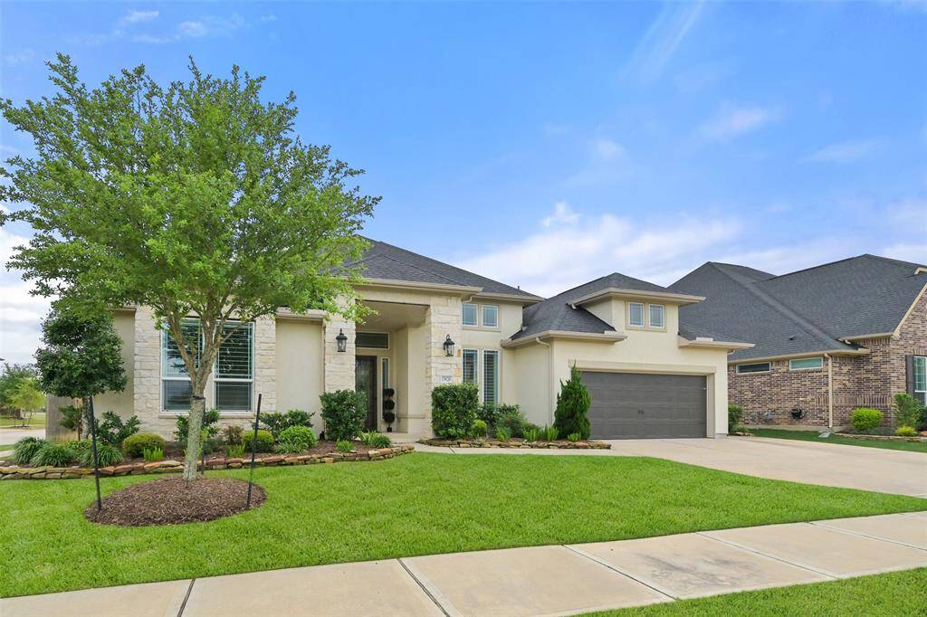 The front exterior of this home is beautifully designed with lush, well-maintained grass and professional landscaping, complemented by an automatic sprinkler system for easy upkeep. The 4-car garage includes 3 traditional spots and 1 tandem parking space, all equipped with automatic garage door openers. The large driveway offers plenty of room for kids to play or additional parking. For added security, a Ring security doorbell is included.