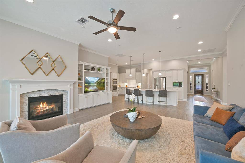 Another view of the family room featuring an open floor plan, seamlessly connecting the kitchen and dining areas—perfect for both everyday living and entertaining. It also opens to the game room, not shown here. For added convenience, the room is pre-wired for speaker installation.