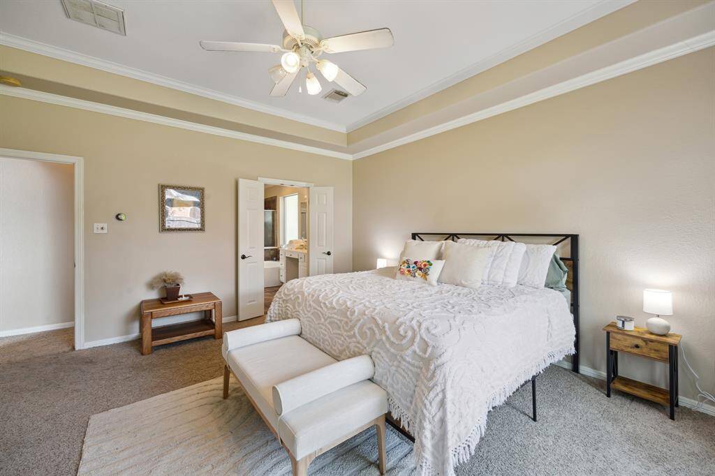 Spacious bathroom featuring a large vanity with dual sinks, a luxurious soaking tub, and a separate glass-enclosed shower. The neutral color palette and ample lighting create a bright and inviting atmosphere.