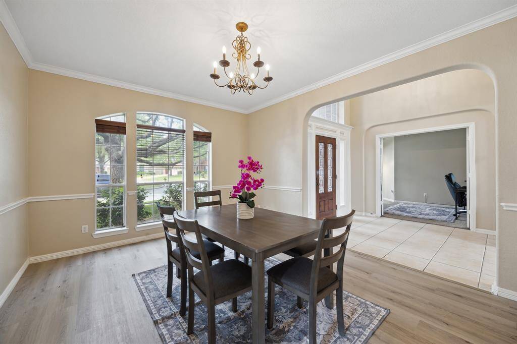 This bedroom is a bright, carpeted space with neutral walls, featuring a single window allowing natural light. It has a Jack and Jill bathroom leading to another large bedroom on the second floor