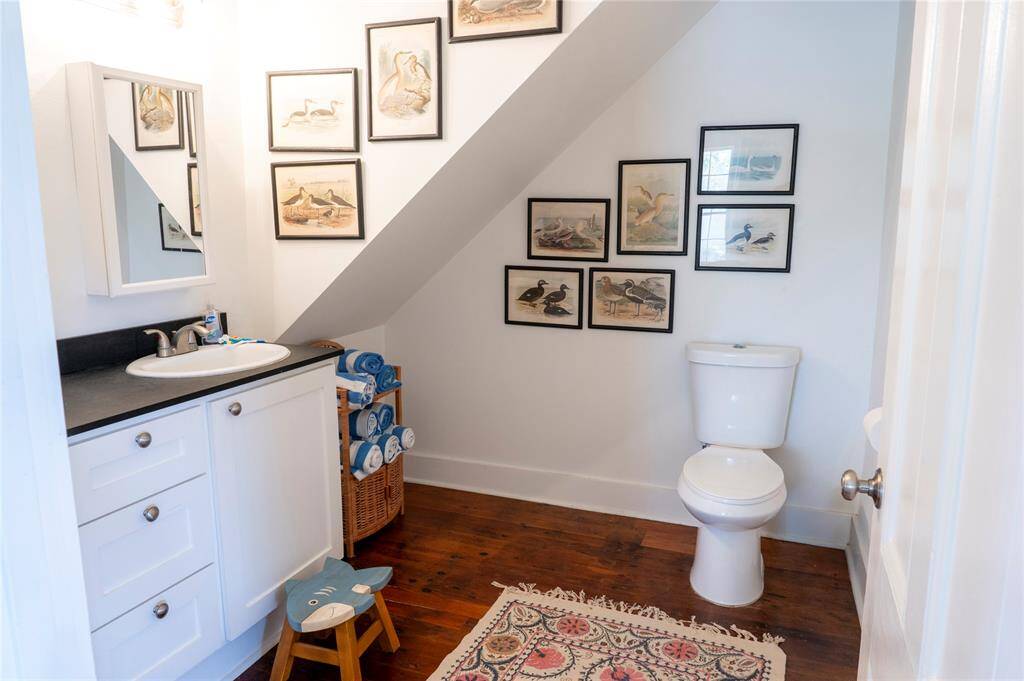 Charming main-level half-bath with elegant fixtures and stylish decor.