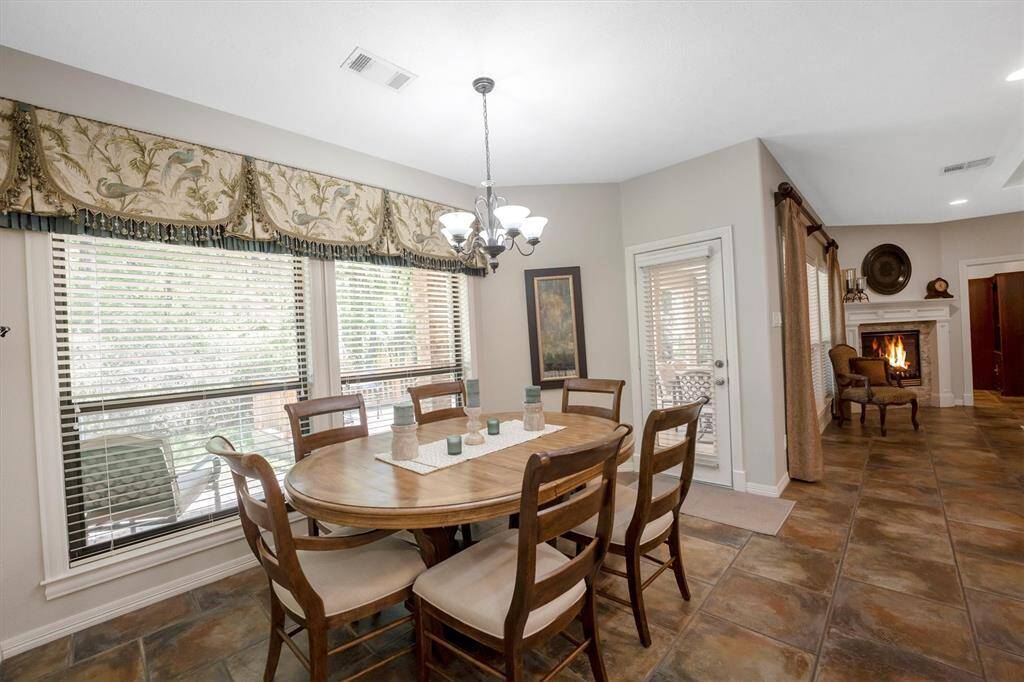 The breakfast room adjoins the living area and kitchen with backyard views