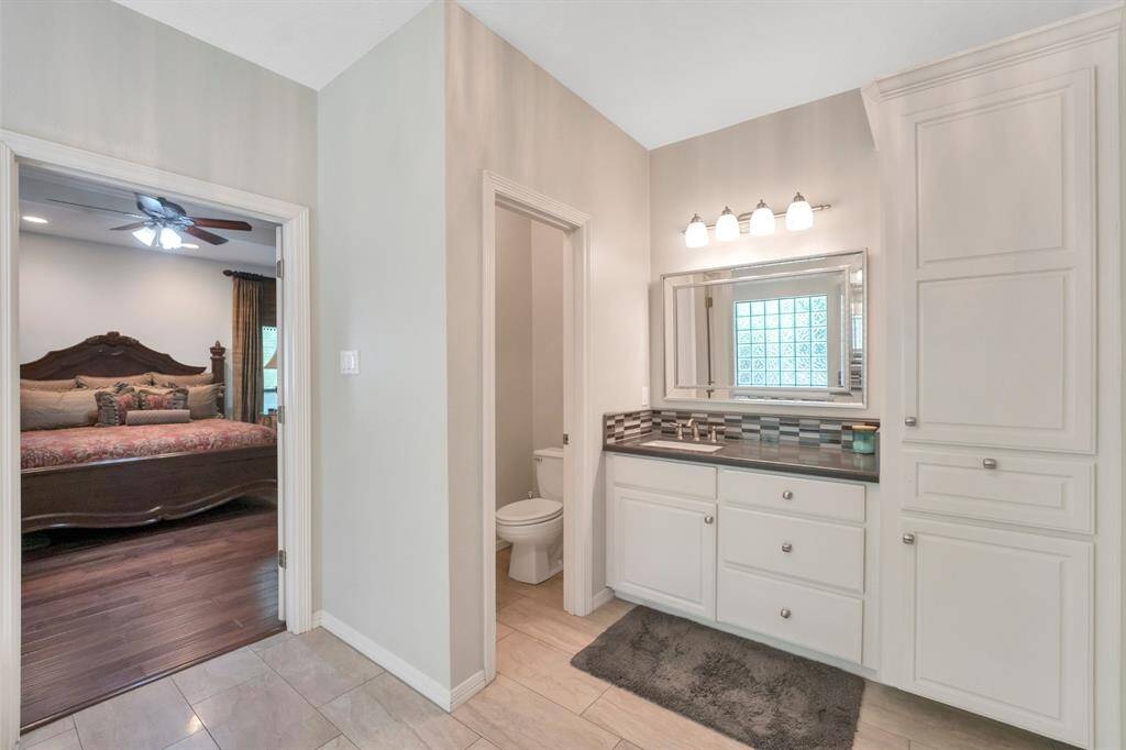 Primary bath has his and her vanities