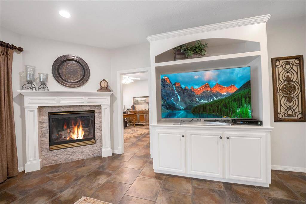 Built in entertainment system in the living room with cozy gas log fireplace